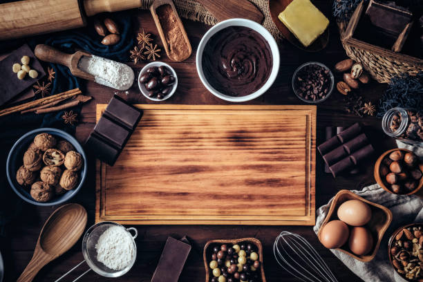istock Making chocolate mousse and ingredients around a cutting board frame on a wooden table rustic kitchen 1153740508