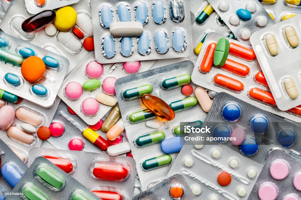 Background of a large group of assorted capsules, pills and blisters Health themes. Background of a large group of assorted capsules, pills and blisters. Drug abuse. Medicine Stock Photo