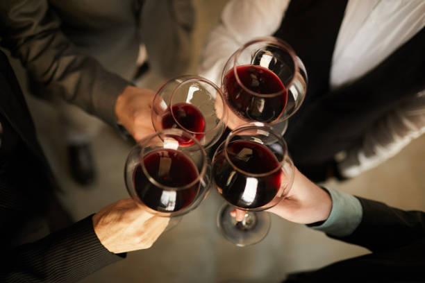 Business people Drinking Wine Above View Top view closeup of people in formalwear clinking wine glasses during event, copy space exclusive dinner stock pictures, royalty-free photos & images