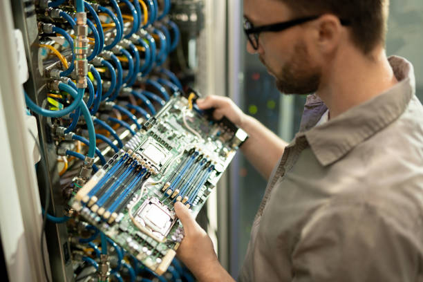 istock IT support specialist examining motherboard of server 1153742577