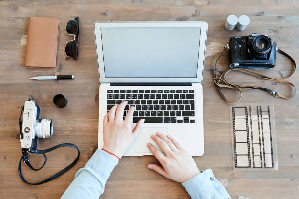 istock Photographer checking shoots on laptop 1153742748