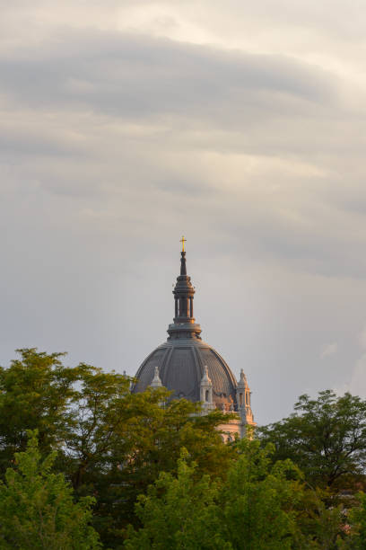 istock shiny cross on church dome in cloudy sky 1153747254