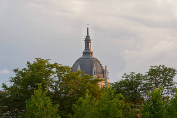shiny cross on church dome in colorful cloudy sky