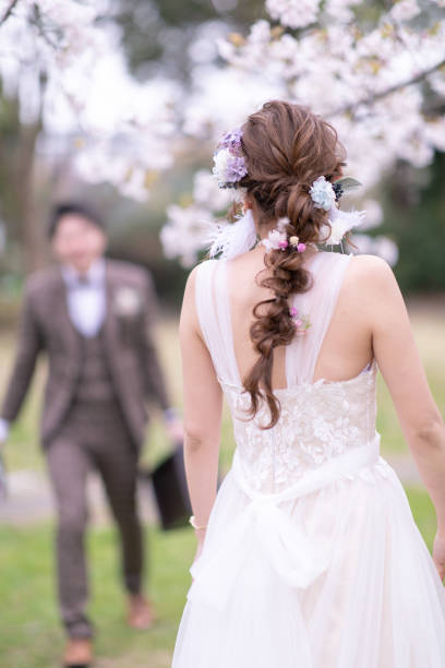 istock Groom walking to the bride under cherry blossoms 1153751251