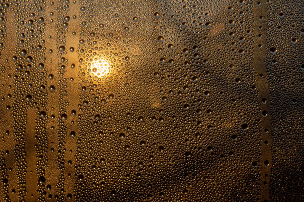 istock sunset through misted glass with drops and drips 1153751380