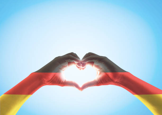 istock Germany national flag on people heart shape hands. 1153752285