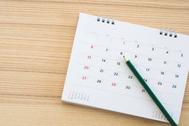 istock calendar page with pencil on wood table background 1153752381