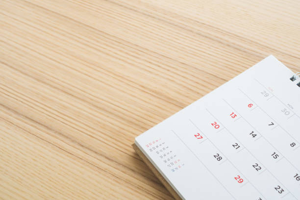 istock calendar page on wood table background 1153752388