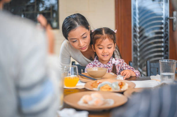 istock Smiling woman helping her daughter in back yard 1153752440