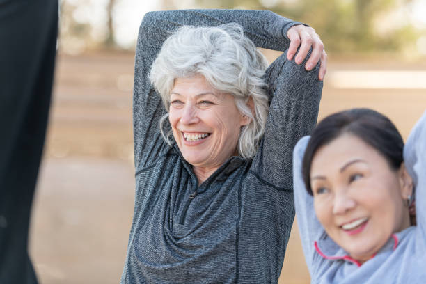 istock Senior Best friends Stretching Outside 1153753797