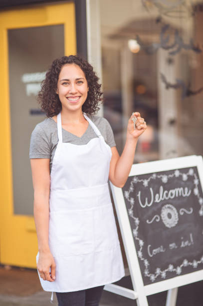 istock Ethnic entrepreneur holds up keys to her new store 1153753847