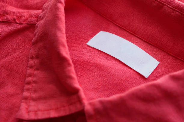 istock White blank clothing tag label on red linen shirt fabric texture background 1153753871