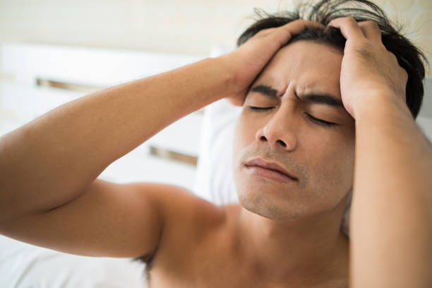 istock Worried man sitting on bed in the morning, serious thinking something 1153753895
