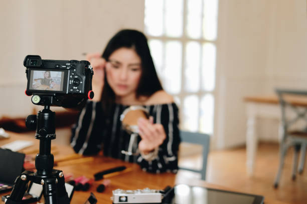 istock beauty blogger live broadcasting cosmetic makeup tutorial on social media. 1153753952