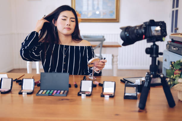 istock beauty blogger live broadcasting cosmetic makeup tutorial on social media. 1153753955