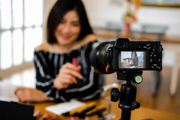 istock beauty blogger live broadcasting cosmetic makeup tutorial on social media. 1153753960
