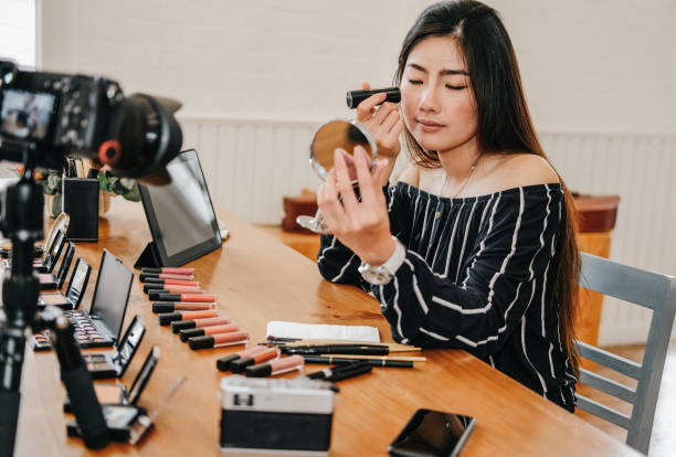 istock beauty blogger live broadcasting cosmetic makeup tutorial on social media. 1153753961