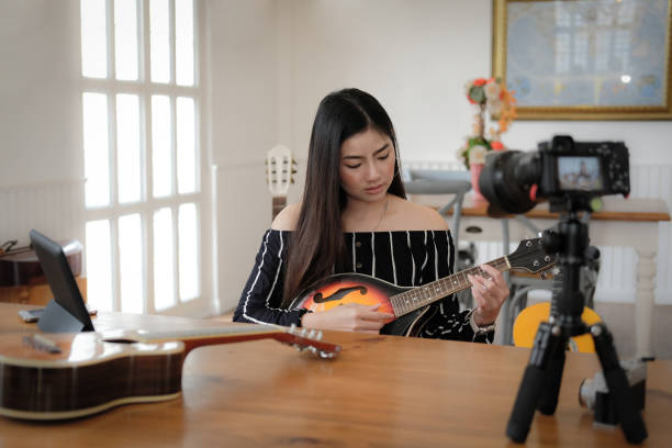 istock blogger live broadcasting music instrument tutorial on social media. vlogger recording online vlog video. 1153754003