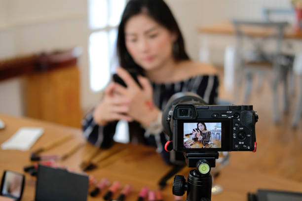 istock beauty blogger live broadcasting cosmetic makeup tutorial on social media. 1153754120