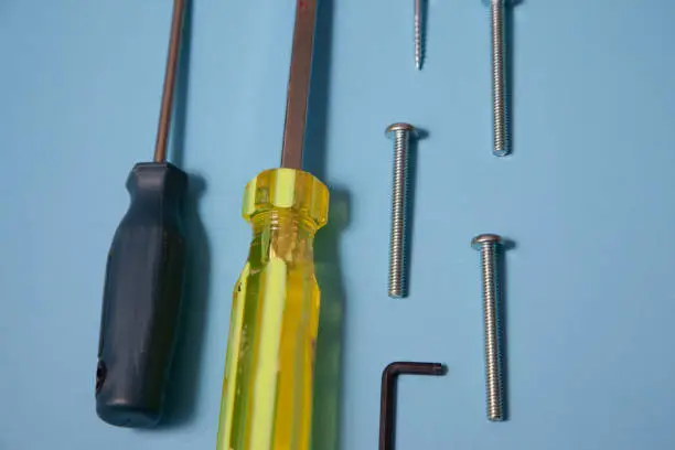 Close up view of screws and a manual screwdriver