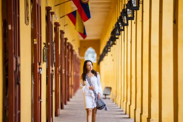 Beautiful woman walking along Las Bovedas building in Cartagena de Indias