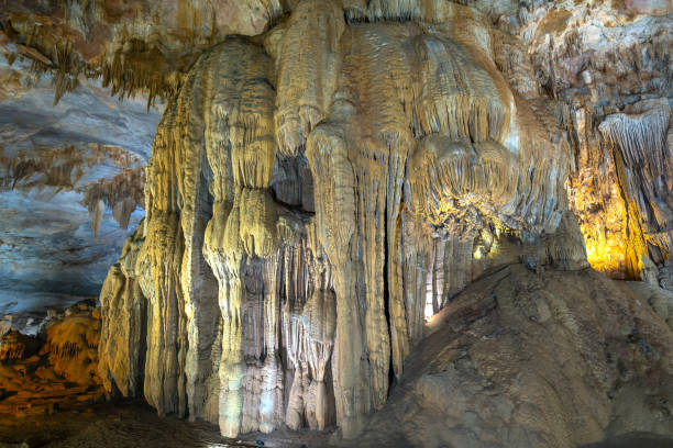 istock Cave-shaped limestone geological formations with beautiful stalactites and stalagmites 1153759939