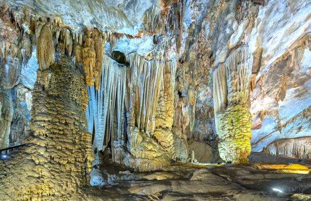 istock Cave-shaped limestone geological formations with beautiful stalactites and stalagmites 1153759975