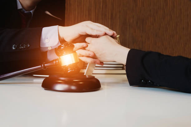 istock smart lawyer give advice and holding clients hands in the office before considering the judgment, lawyer concept