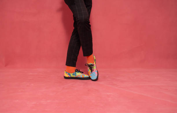 istock one man, showing his new sneakers. 1153762282