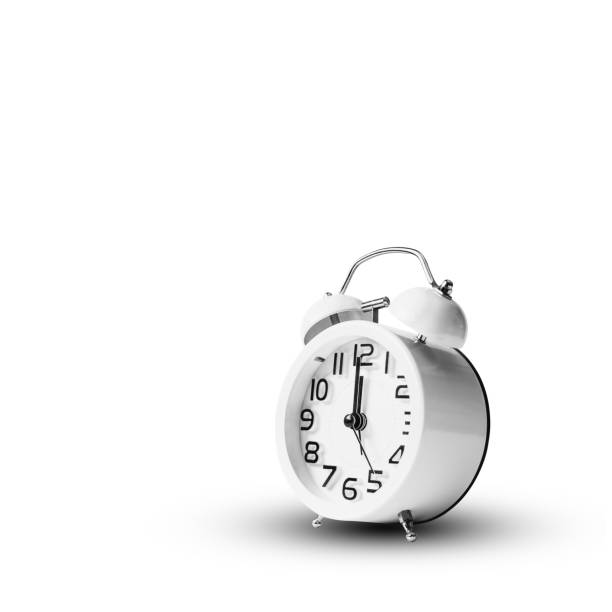istock White vintage alarm clock on white background. 1153763101