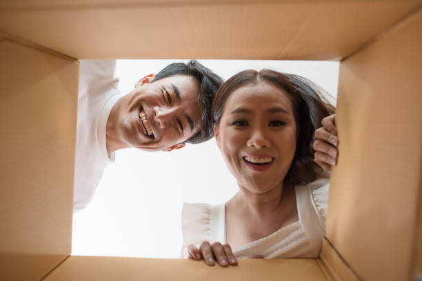 Asian young heterosexual couple sending gift
