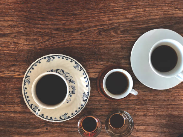 istock Espresso shot cup and Black coffee on white cup on wooden table. Top view and copy space. Coffee cupping. 1153770022