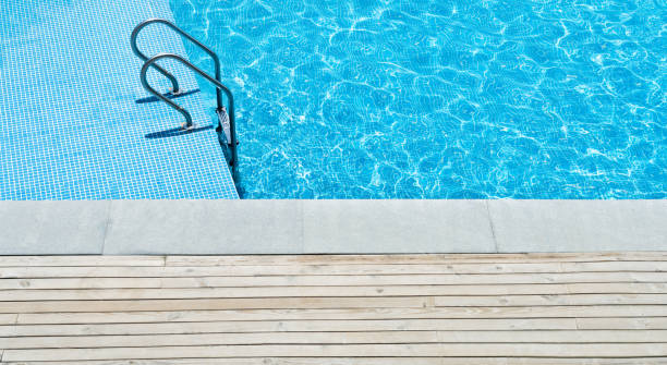 istock Swimming pool with stair at hotel close up 1153772575