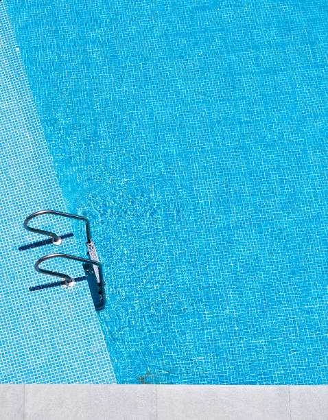 istock Swimming pool with stair at hotel close up 1153772580