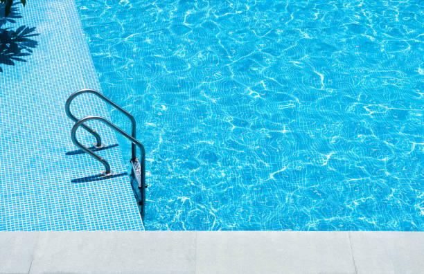 istock Swimming pool with stair at hotel close up 1153772607