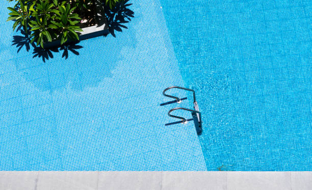 istock Swimming pool with stair at hotel close up 1153772633