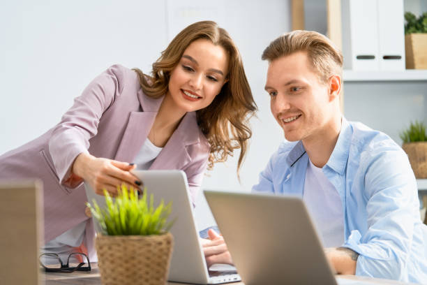 istock man and woman working in the office 1153772716