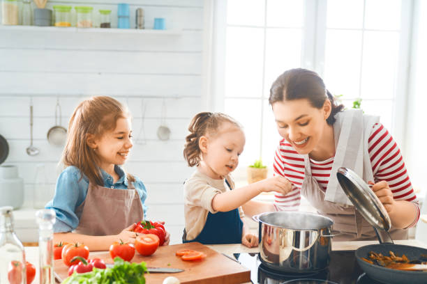 istock Happy family in the kitchen. 1153773393
