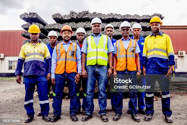 Group Portrait Of Confident African Steel Factory Worker Team In Africa Stock Photo - Download Image Now