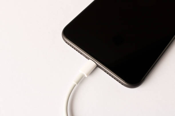 istock Smartphone on charge . On white background. Close up. 1153775559