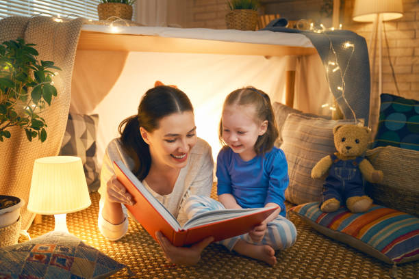 istock Mom and child reading a book 1153779482