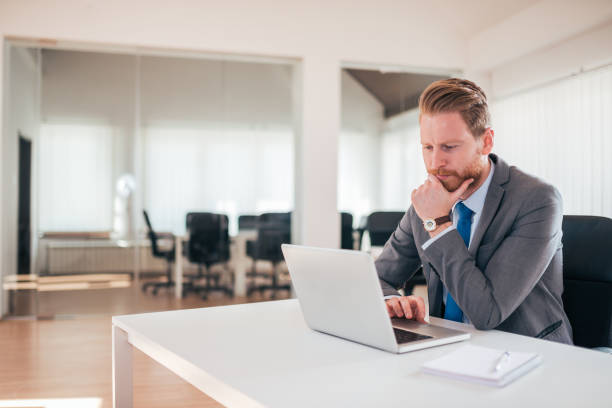 istock Young businessman pondering over ideas for new business project. 1153779765