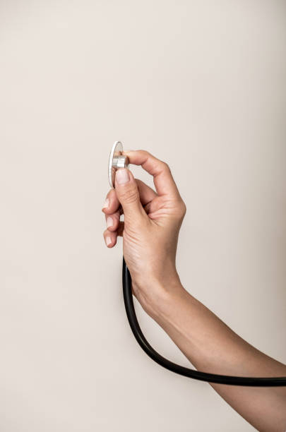 Hand of a doctor holding a modern stethoscope stock photo