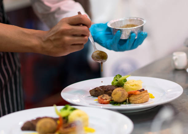 istock Chef cooking food in the kitchen, Chef preparing food 1153782848