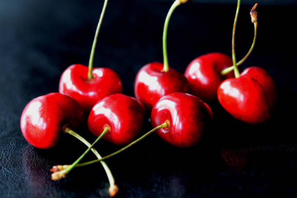istock A few berries ripe cherry on a dark background close up 1153782945