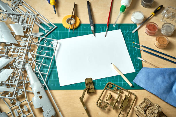 istock Top view on plastic model scale with accessories on  green pad on  wooden table 1153785187