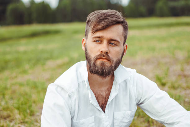 istock the guy with the beard sitting on the grass 1153795026