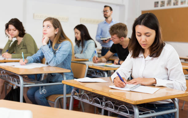 istock schoolgirl is sitting test and answer about task 1153796018