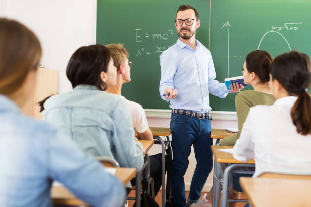 istock Male teacher giving lecture for students 1153796050