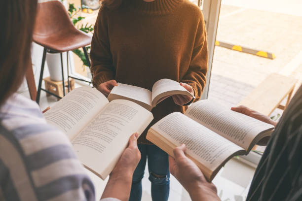 istock people standing in circle and enjoyed reading books together 1153796164